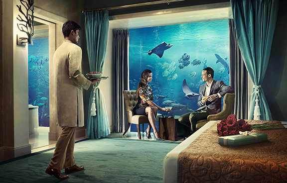 Underwater suite in Atlantis: The Palm, Dubai features immense floor-to-ceiling windows into their 65,000 marine animal Aquarium in Dubai.